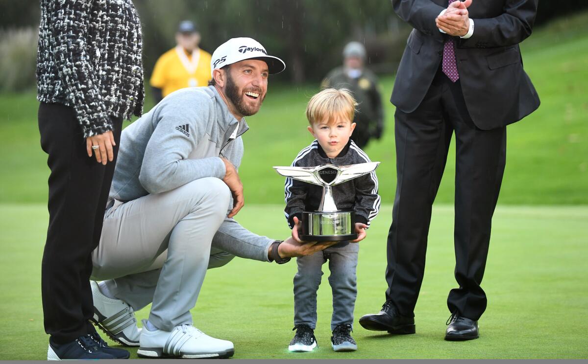 Dustin Johnson shares the Genesis Open trophy with his son, Tatum.