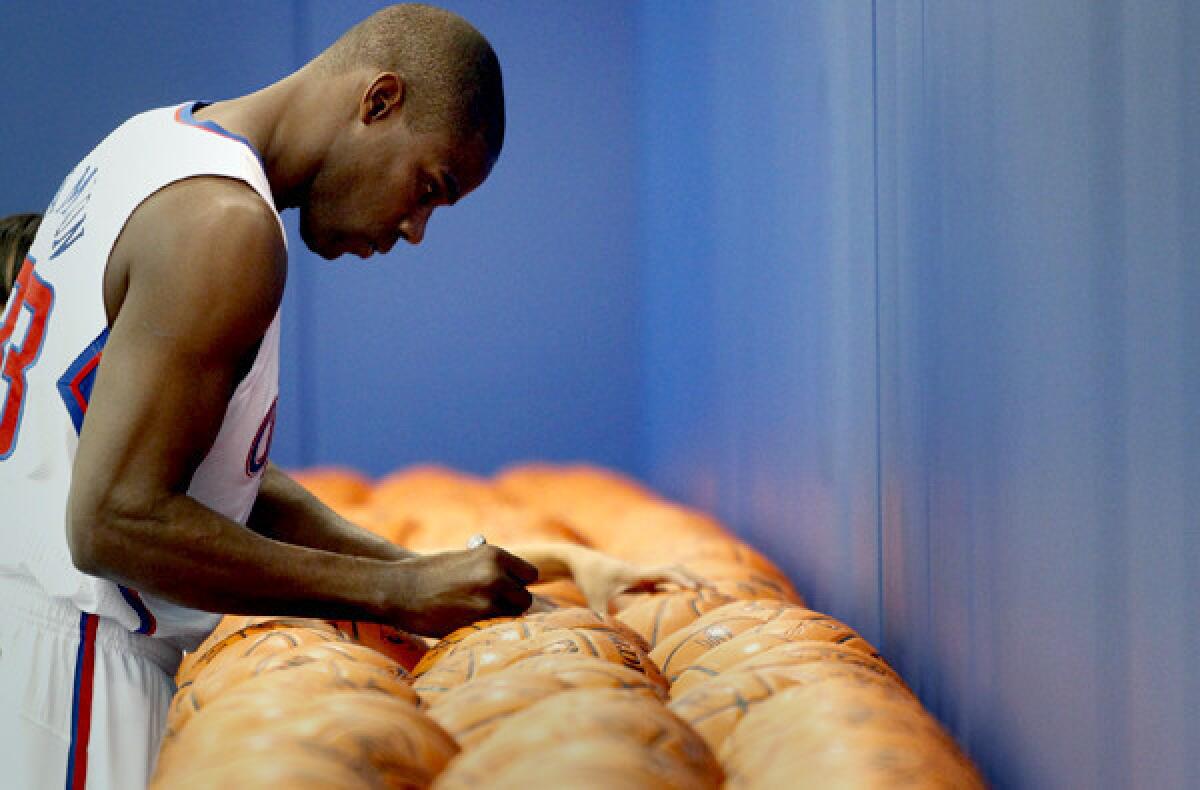 Veteran forward Antawn Jamison signs basketballs during the Clippers' media day.