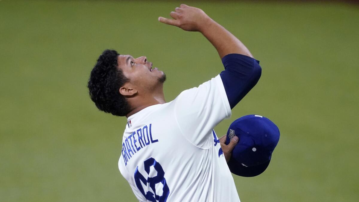 Dodgers relief pitcher Brusdar Graterol celebrates after a catch by Cody Bellinger 