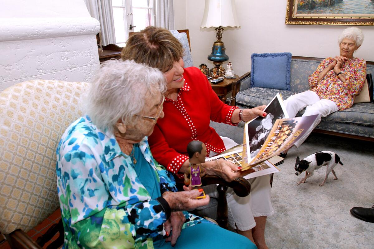 Gertrude Ness receives Lakers memorabilia, including Kobe Bryant's autograph, from Glendale Mayor Paula Devine, center, as Ness' friend Patti Mack looks on at her home in Glendale on Tuesday, June 21, 2016.