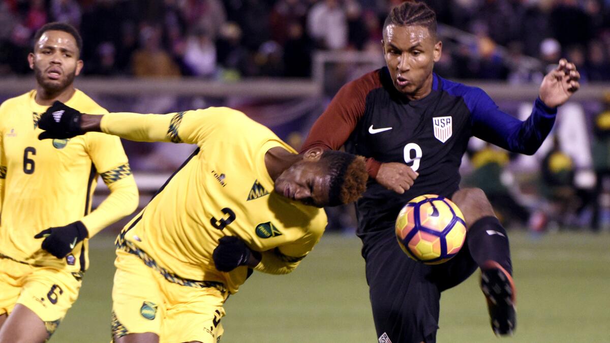 U.S. forward Juan Agudelo (9) tries to receive a pass as he's defended by Jamaica's Damion Lowe (3) during the first half Friday.