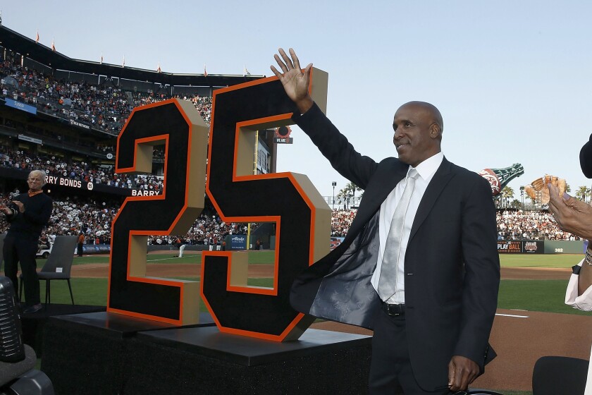 Former San Francisco Giants player Barry Bonds waves during a ceremony to retire his jersey number 
