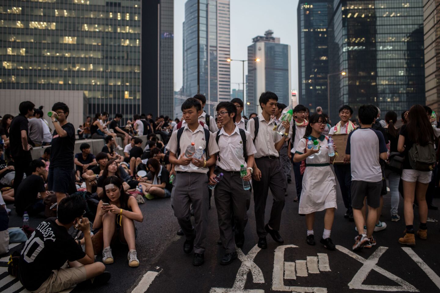 High school students hand out water and food outside the Hong Kong government center.