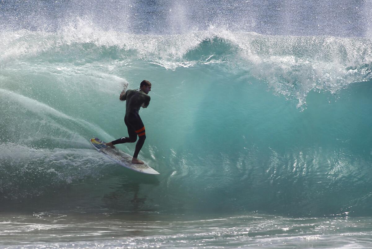 A surfer hits the waves at the Wedge in Newport Beach in October. Fifteen-foot waves are expected there this weekend.