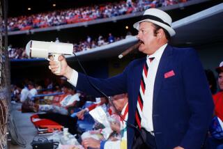 Dodger scout Mike Brito is seen in his familiar position at Dodger Stadium, behind home plate with radar gun in hand