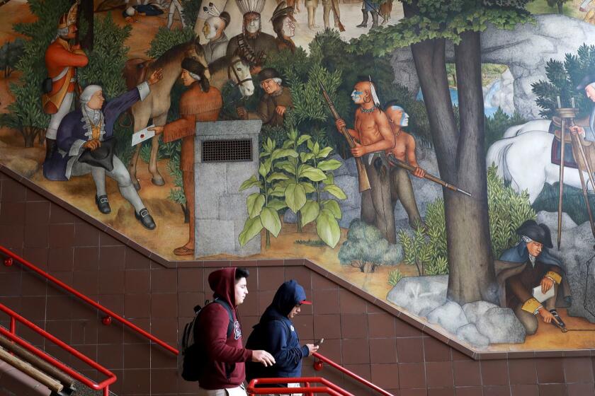 A mural depicts the treatment of American Indians and African Americans. 