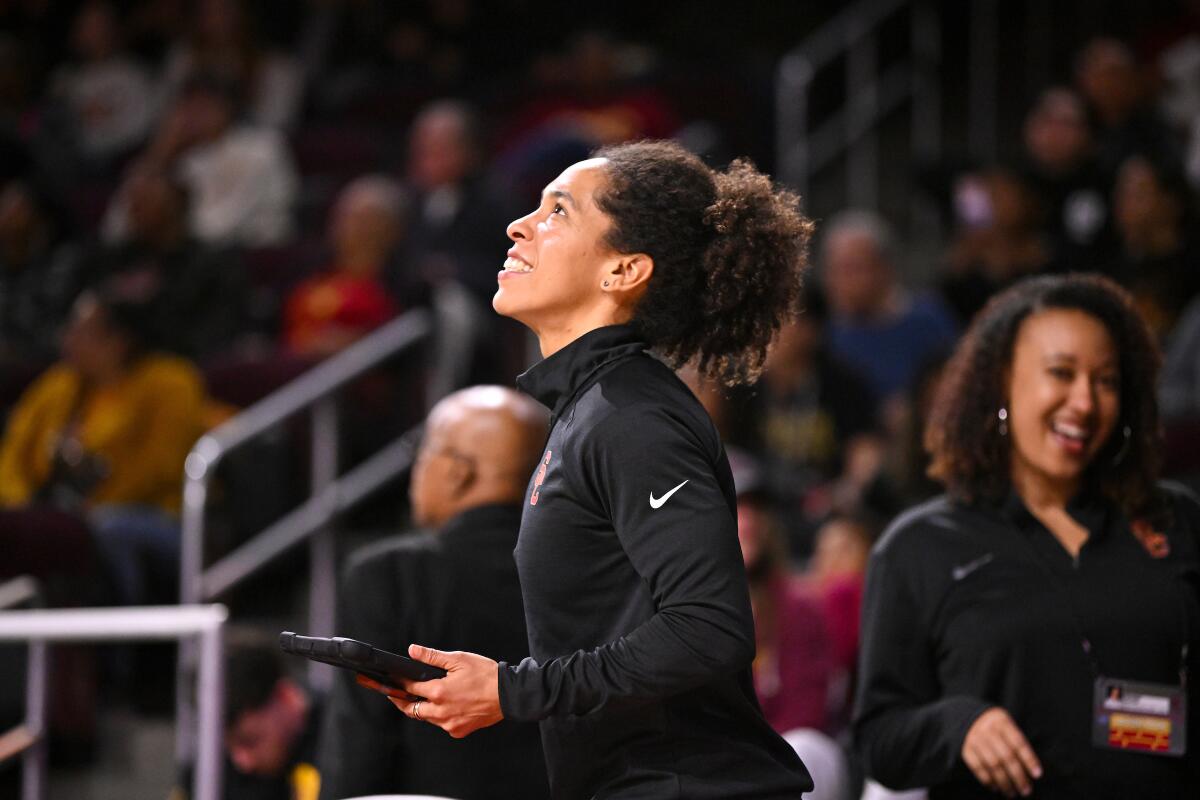 Kelly Dormandy, director of sports performance of the USC women's basketball team, stands on the sideline during a game.