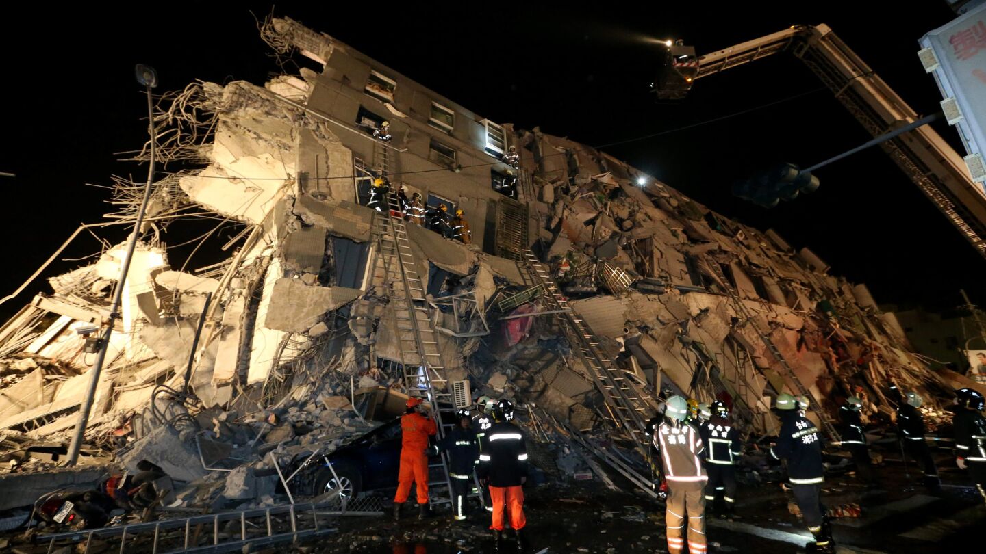 Rescue personnel search for survivors at the site of a collapsed building in the southern Taiwanese city of Tainan.