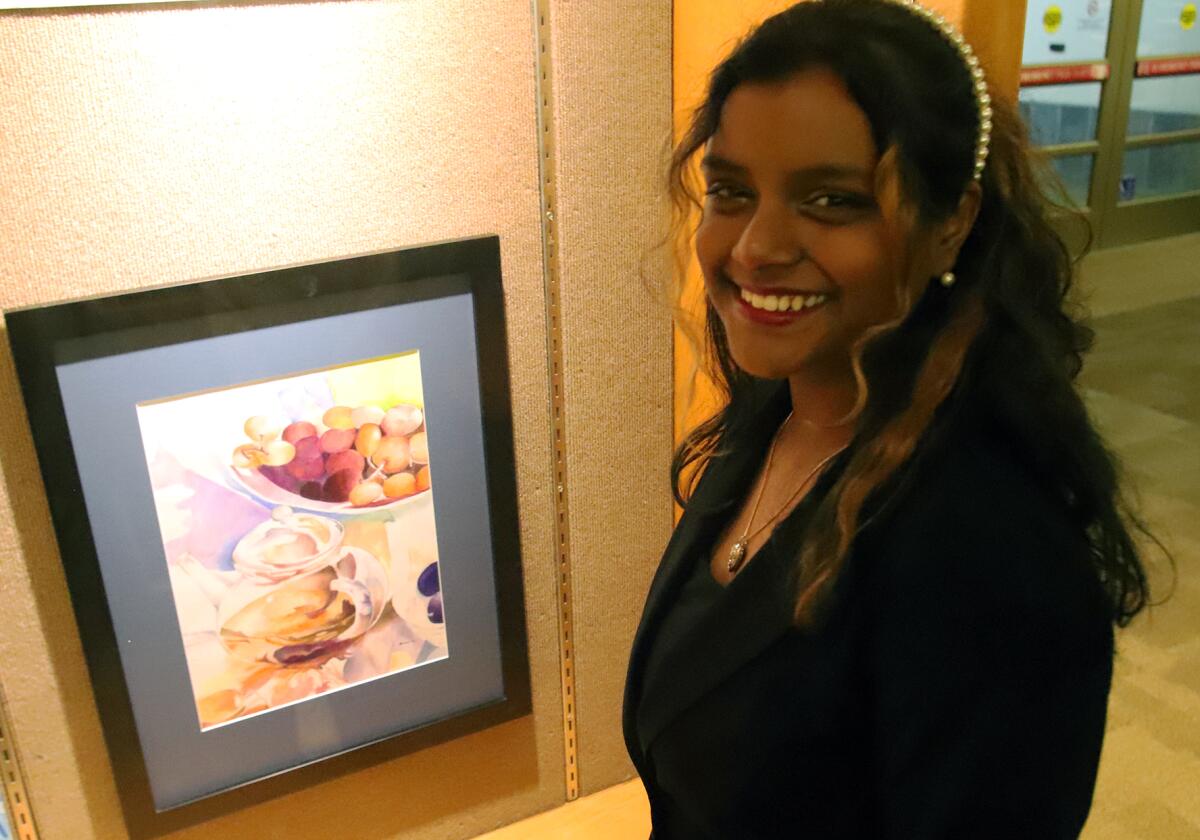 Shivani Atluri, 14, from the Orange County School of Arts, next to her painting titled "Tea Time."