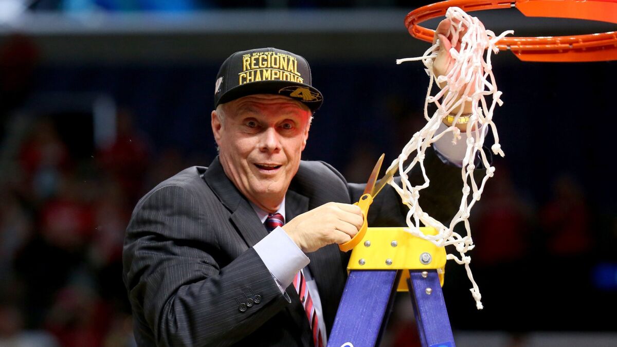 Wisconsin Coach Bo Ryan cuts down the net after the Badgers' victory over Arizona in the NCAA tournament West Region final at Staples Center on Saturday.