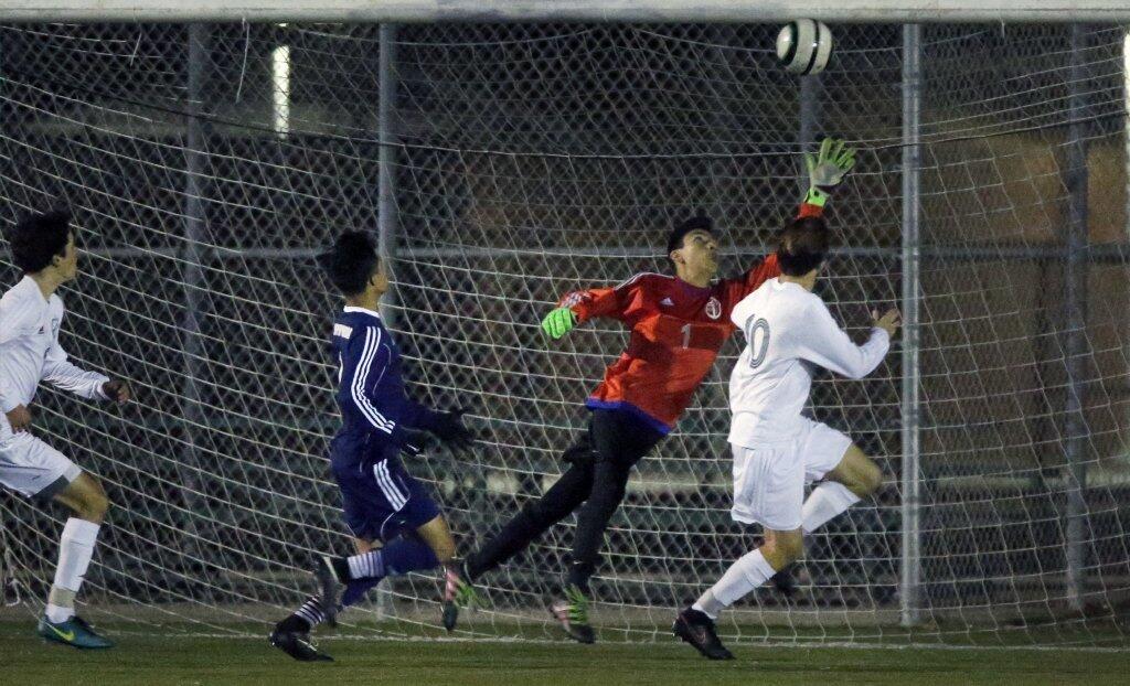 Newport Harbor goalie Damian Ramos stops a ball off Edison in the second half of a Sunset League soccer game on Friday.