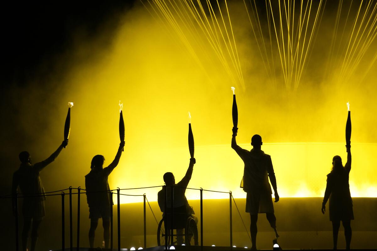 Athletes Charles-Antoine Kouakou, Nantenin Keita, Fabien Lamirault, Alexis Hanquinquant and Elodie Lorandi look up.