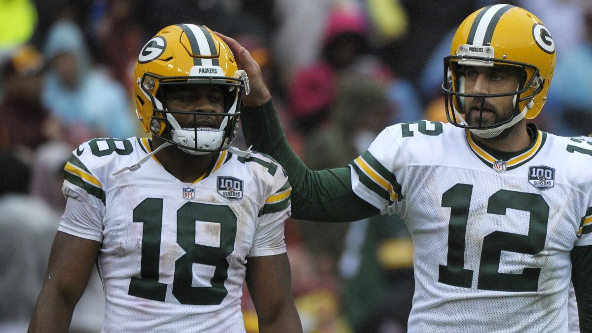 Green Bay Packers quarterback Aaron Rodgers (right) and wide receiver Randall Cobb (left) celebrate a touchdown.