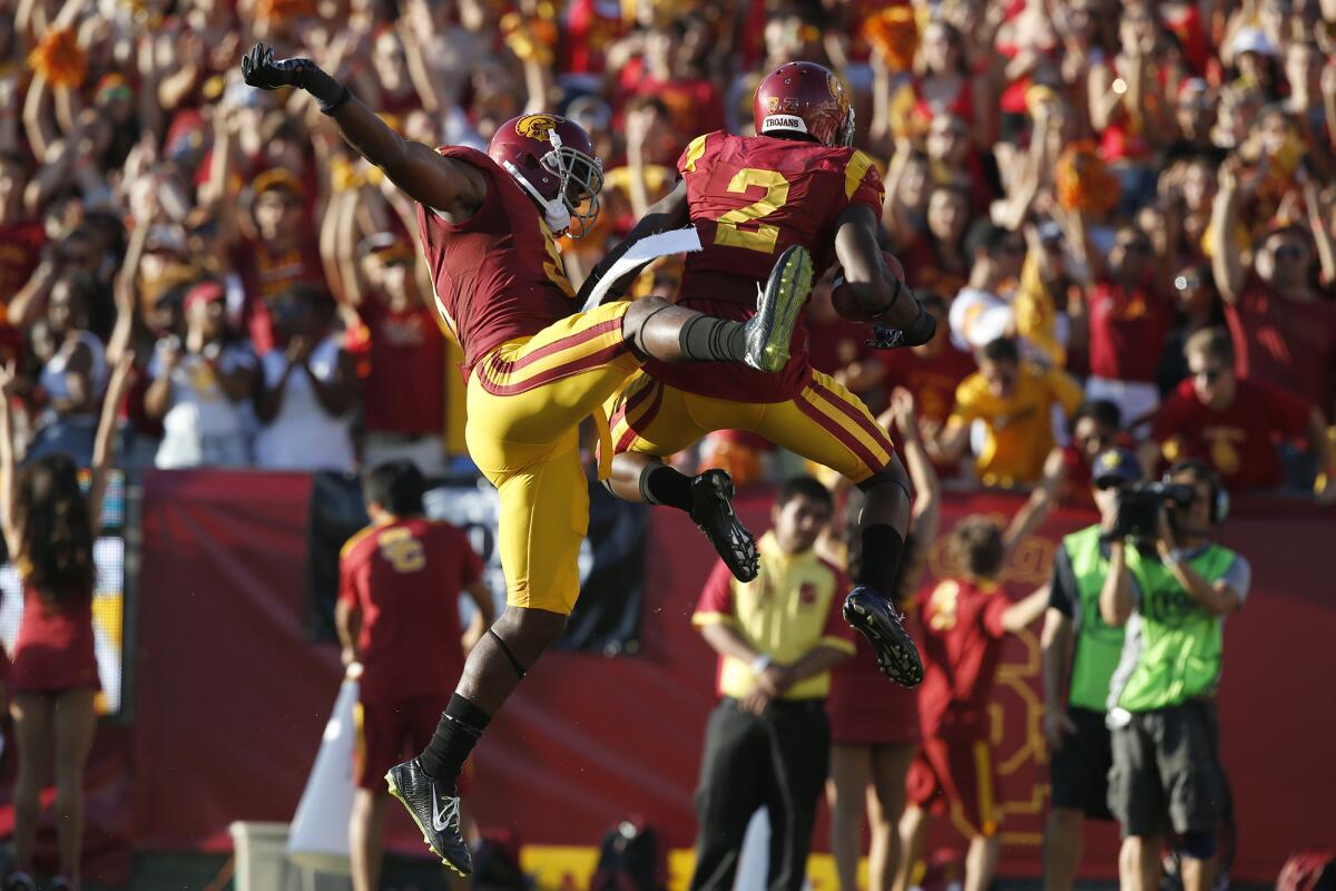 USC receivers Juju Smith, left, and Adoree' Jackson celebrate a touchdown by Jackson late in the second quarter in Saturday's game against Fresno State.