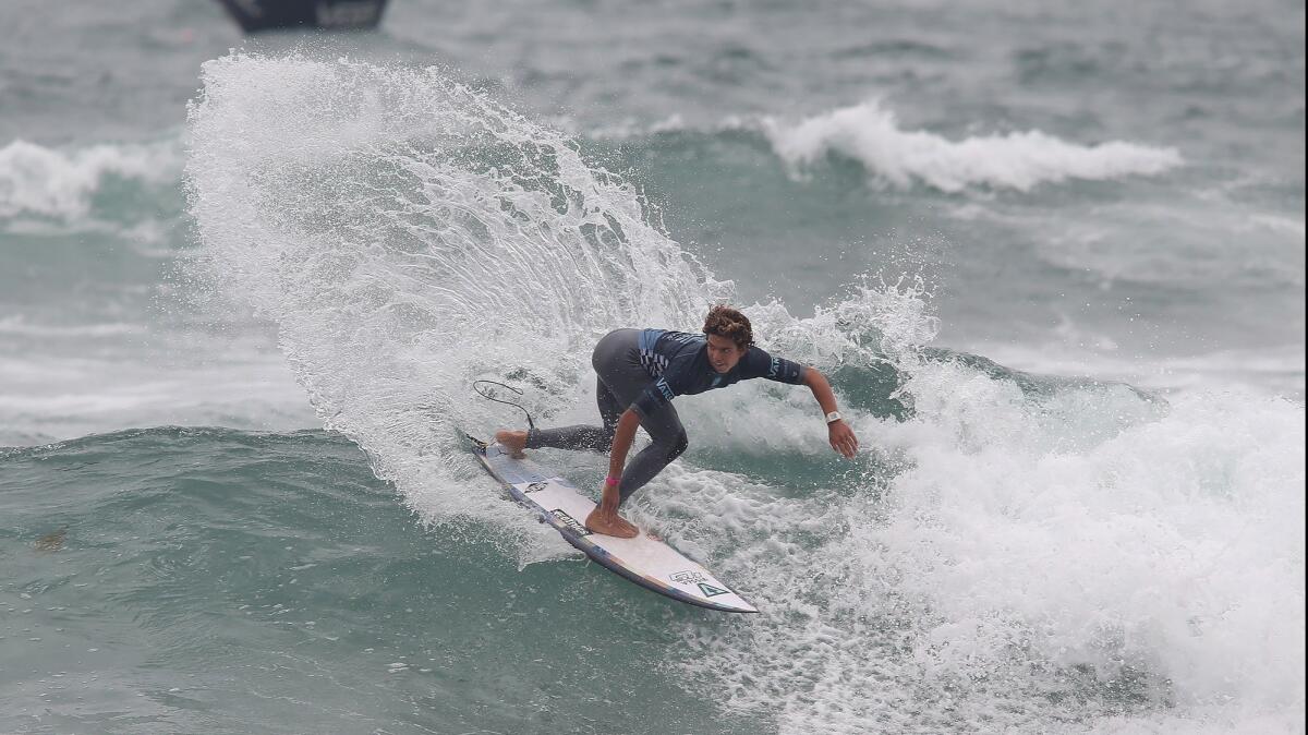 Cole Houshmand, seen making a backside hook during the Junior Men's competition at the U.S. Open of Surfing on July 28, is competing in the Vissla International Surfing Assn. World Junior Surfing Championship this weekend.