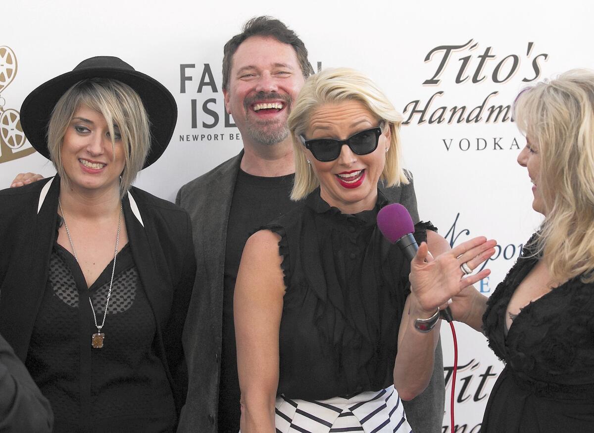 From left, K. Rocco Shields and David Tillman, from "Love is All you Need?," and actress Katherine La Nasa laugh as they arrive at the opening night red carpet party for world premiere of "After the Reality" at the Edward's Big Newport on opening night of the 2016 Newport Beach Film Festival on Thursday.