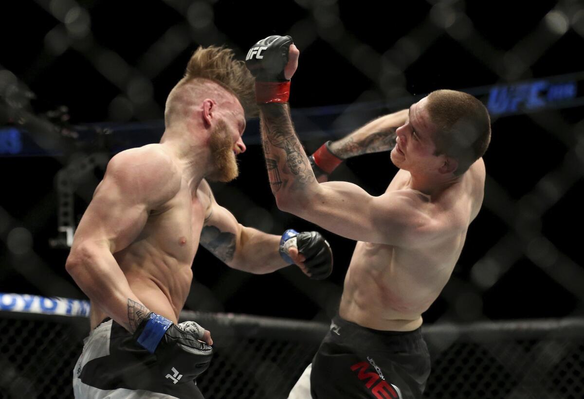 Emil Meek, left, and Jordan Mein of Canada trade punches during their welterweight fight at UFC 206.