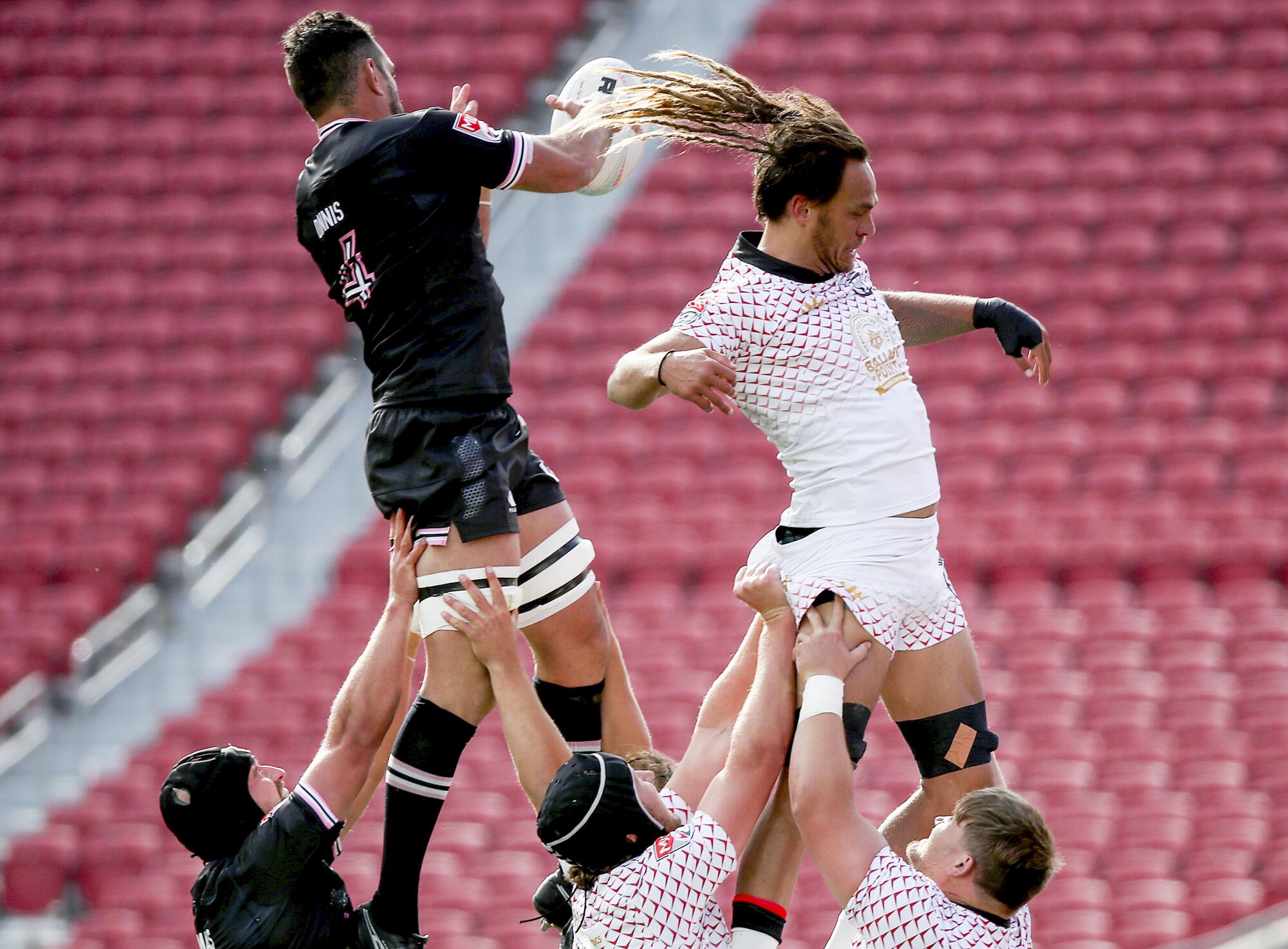 San Diego Legion and Los Angeles Giltinis players fight for ball possession in a rugby formation called the lineout.