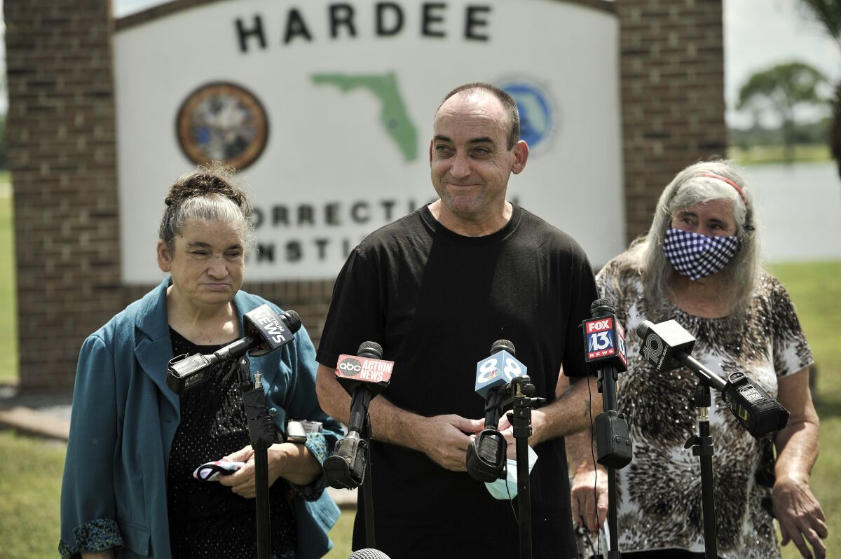 FILE - In this Aug. 27 2020 file photo, former inmate Robert DuBoise, 56, meets reporters with his sister Harriet, left, and mother Myra, right, outside the Hardee County Correctional Institute after serving 37 years in prison, when officials discovered new evidence that proved his innocence in Hardee County, Fla. DuBoise, exonerated of a 1983 rape and murder after serving 37 years in prison is suing over his wrongful conviction in which a a questionable bite mark was critical evidence. (AP Photo/Steve Nesius, File)