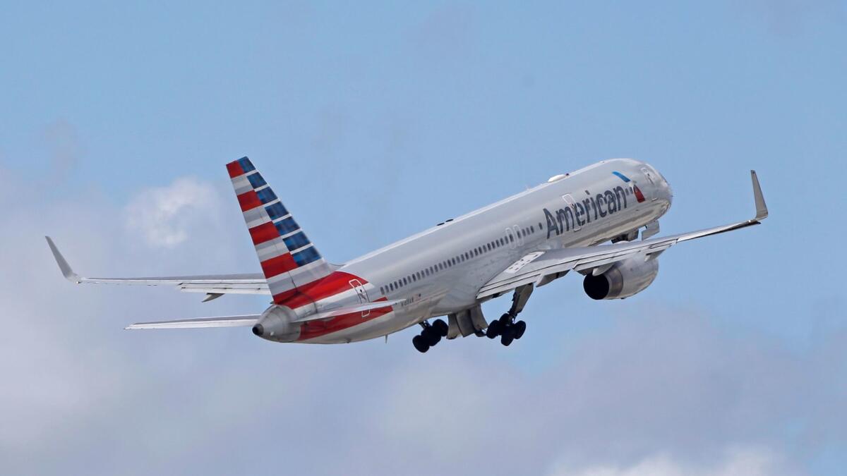 An American Airlines passenger jet takes off from Miami International Airport in Miami. The Fort Worth-based carrier has reached an agreement with its pilots to avoid canceling flights during the Christmas holiday.
