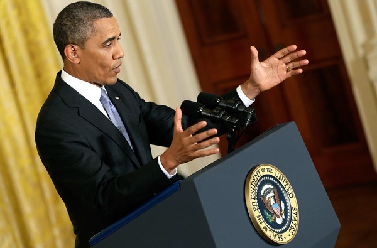 President Barack Obama answers questions during a news conference in the East Room of the White House on Friday.