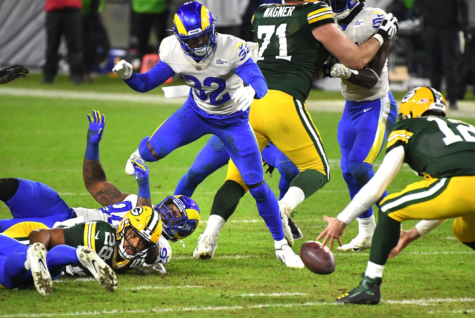 Green Bay Packers quarterback Aaron Rodgers recovers a fumble by running back AJ Dillon during the fourth quarter.