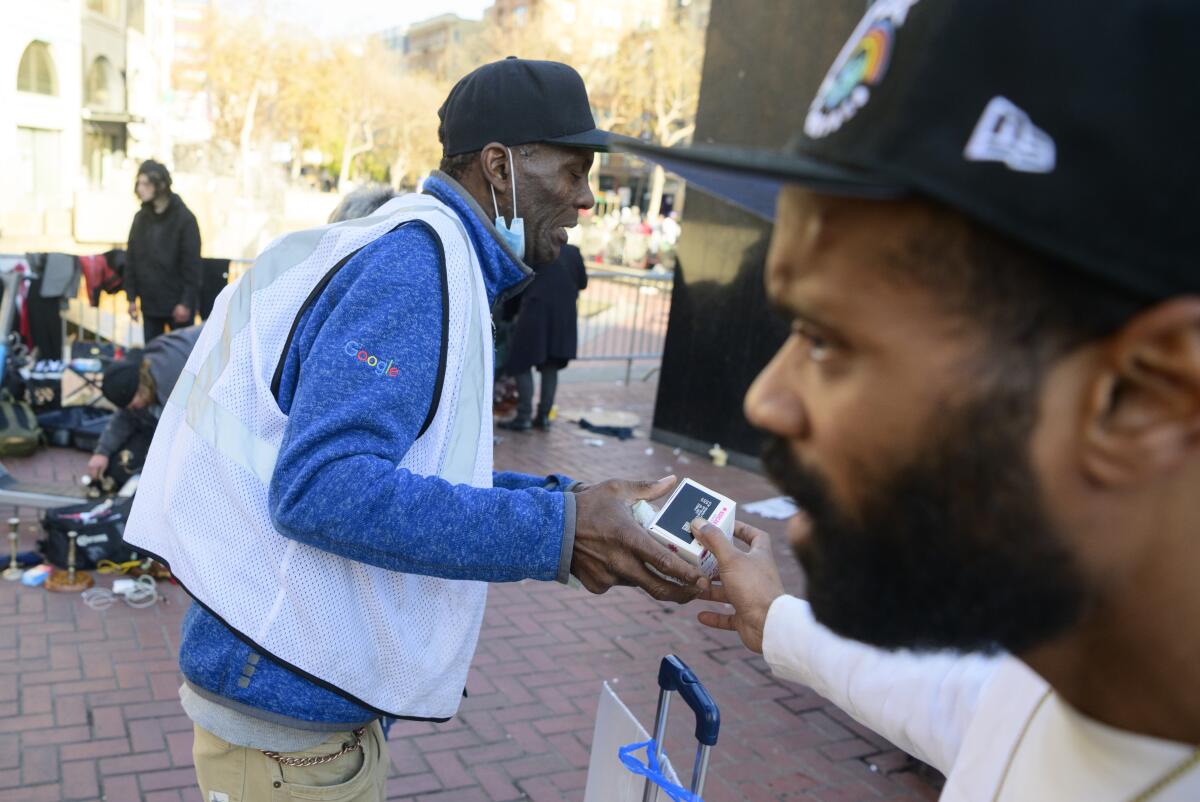 Avieira evans, of Health Right 360, passes out Narcan at UN Plaza ie. (Josh Edelson/for the Times)