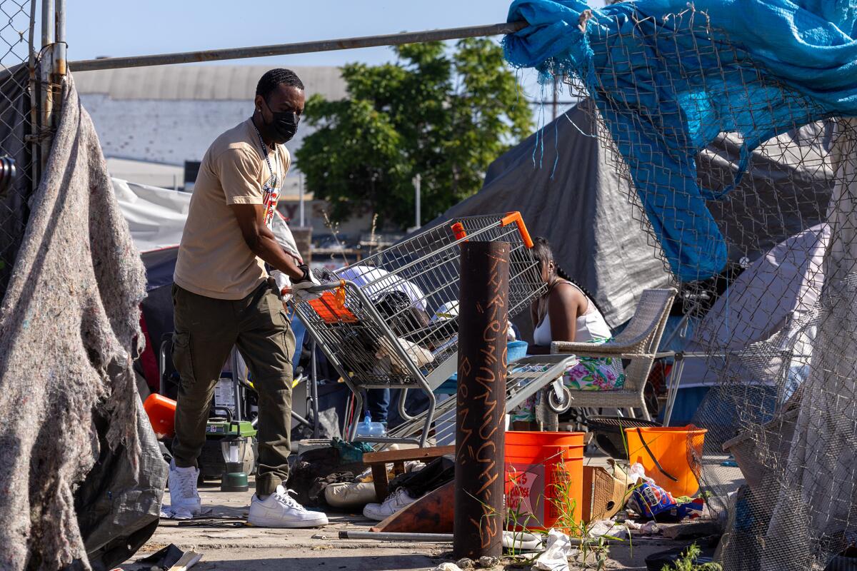 Inside Safe workers clean up a homeless camp to get people out of the encampment and into hotels and  motels