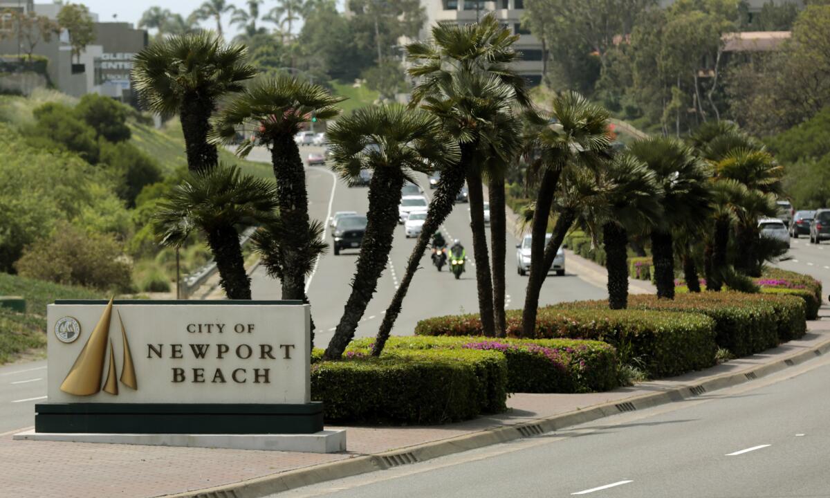 A sign on Newport Boulevard at Industrial Way welcomes visitors to Newport Beach.