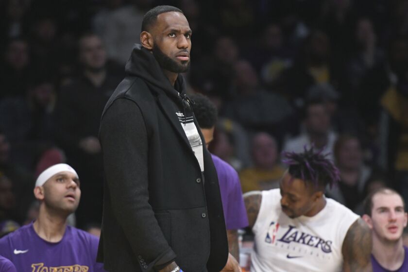 Los Angeles Lakers' LeBron James stands on the sidelines during an NBA basketball game against the Denver Nuggets Sunday, Dec. 22, 2019, in Los Angeles. (AP Photo/Michael Owen Baker)