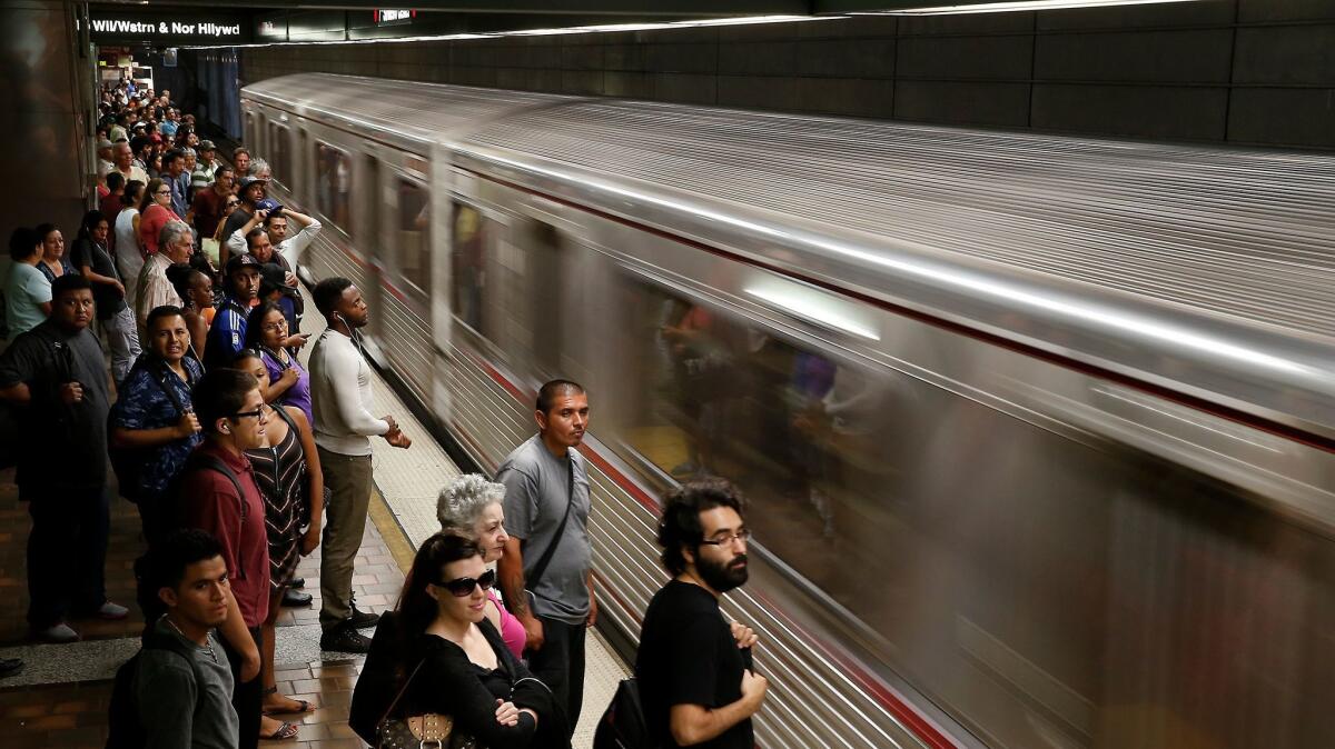 An eastbound train pulls in as commuters wait to board at the 7th Street Metro subway station in 2014. (Robert Gauthier / Los Angeles Times)