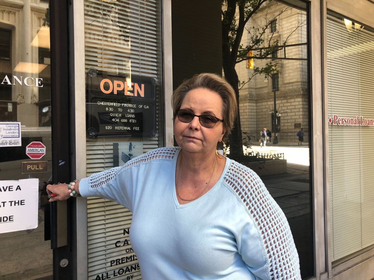 Jackie Dodd, 60, a finance loan officer supporting President Trump, gets ready to push open a door.