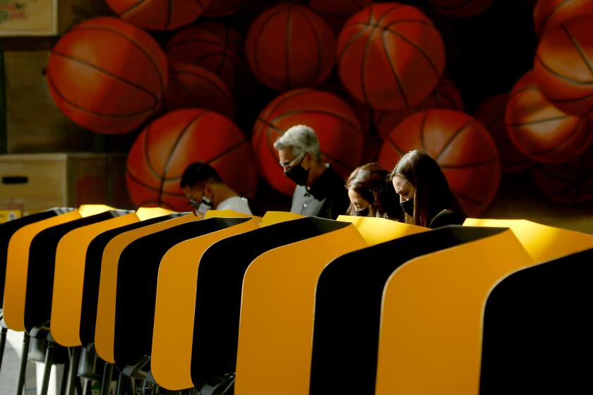 LOS ANGELES, CA - OCT. 30, 2020. Voters fill out their ballots at Staples Center in downtown Los Angeles.