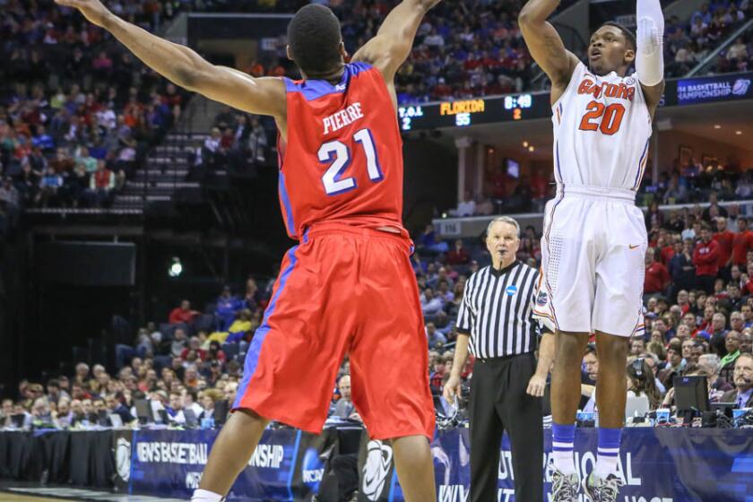 Florida's Michael Frazier II (20) goes up for a three point shot during second half action of an NCAA Elite 8 southern regional final against Dayton at the FedEx Forum in Memphis, TN on Saturday, March 29, 2014. (Joshua C. Cruey/Orlando Sentinel)