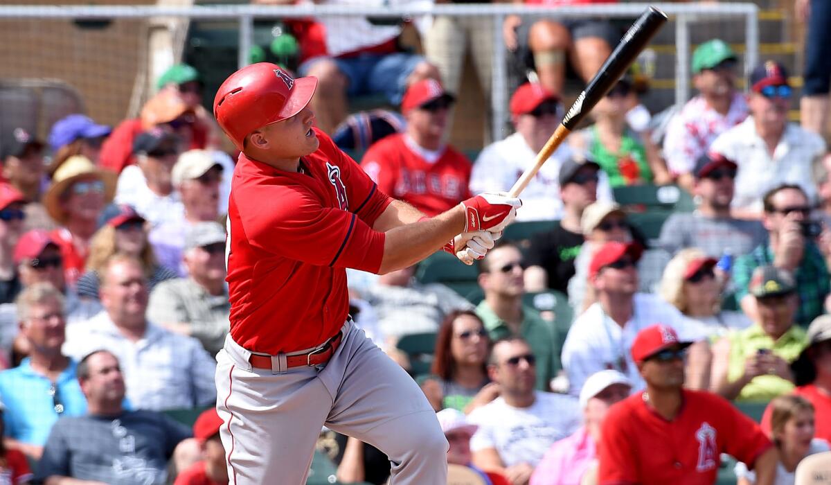 Angels center fielder Mike Trout, shown hitting one of his two home runs against the Cubs on March 17, hit his fourth homer of the spring on Saturday against the Dodgers.