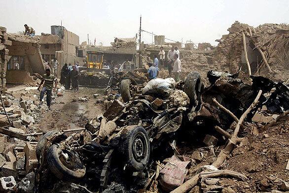 Iraqis search through the wreckage of a truck bomb in Taza Khurmatu, about 10 miles south of Kirkuk, in northern Iraq. The attack in the ethnically diverse region  a mix of Arabs, Kurds and Turkmen  comes less than two weeks before the scheduled withdrawal of most U.S. forces from Iraqi cities.