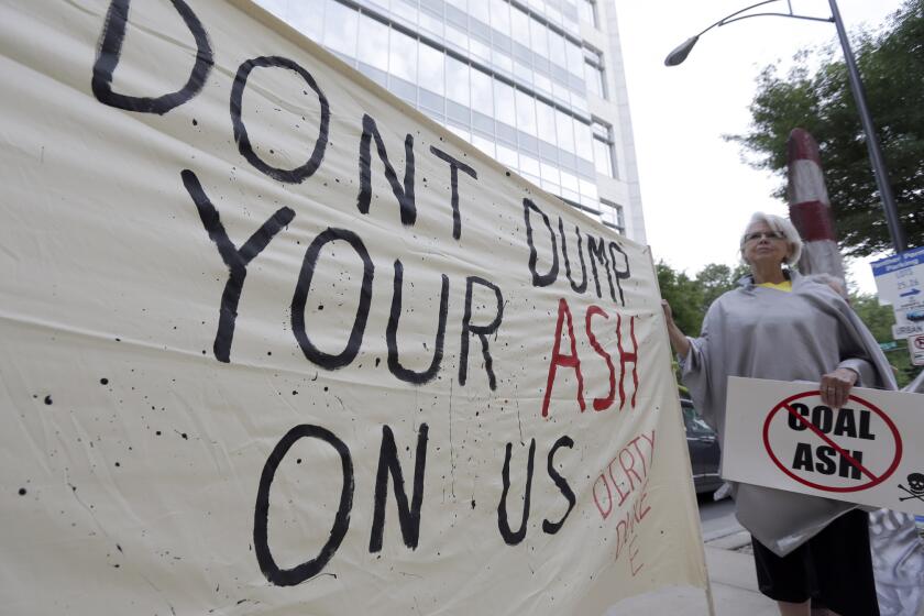 Debbie Hall of Sanford, N.C., protests May 7 outside Duke Energy headquarters before the company's shareholders meeting in Charlotte, N.C. Hall and other North Carolina residents worry about possible pollution from ponds the company uses to store coal ash.