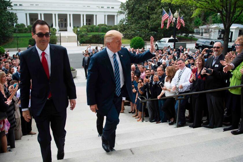 US President Donald Trump (C) waves with Treasury Secretary Steven Mnuchin (L) as they walk from the White House to the US Treasury Department in Washington, DC, April 21, 2017. / AFP PHOTO / JIM WATSONJIM WATSON/AFP/Getty Images ** OUTS - ELSENT, FPG, CM - OUTS * NM, PH, VA if sourced by CT, LA or MoD **