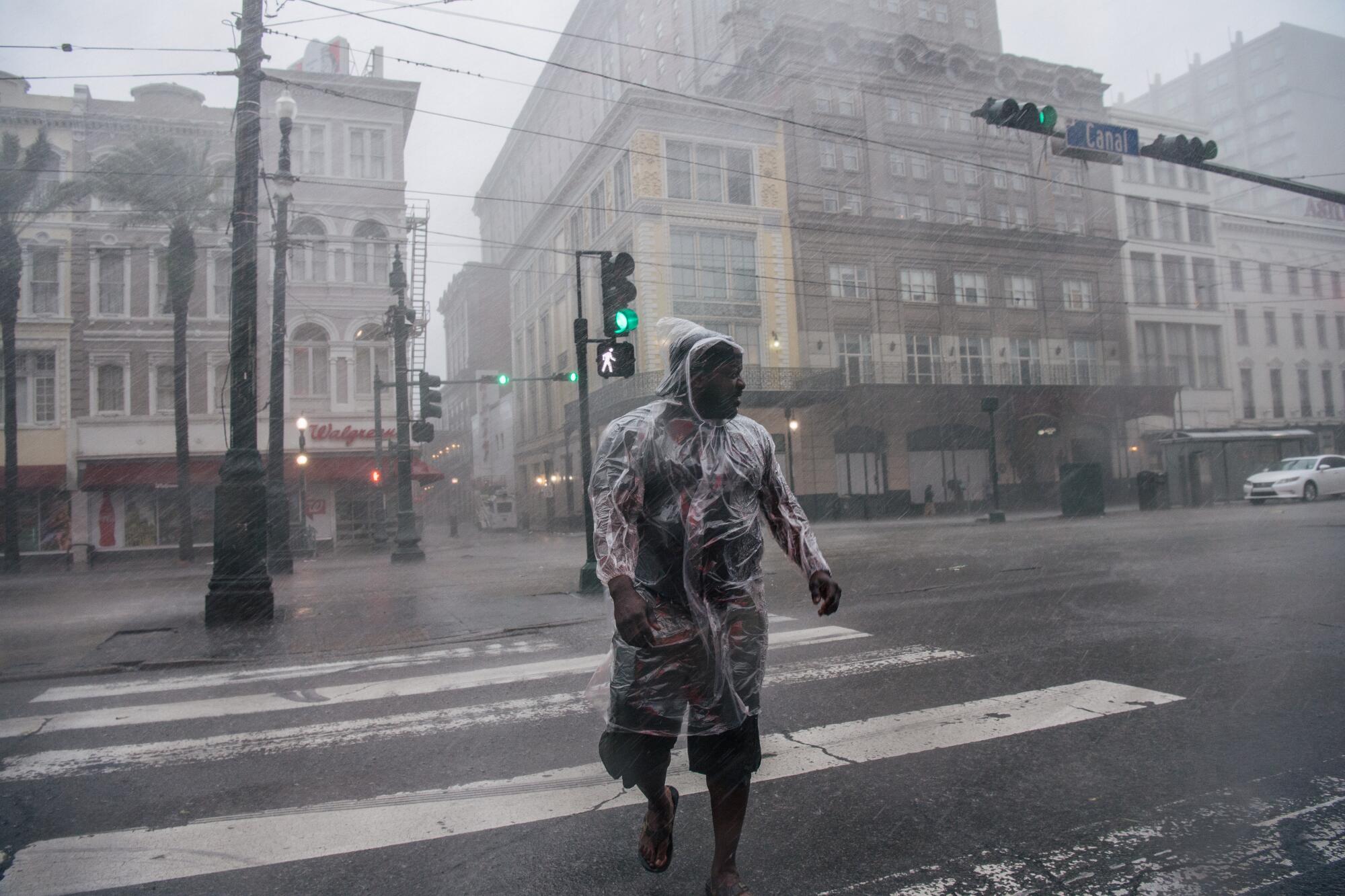 A person crosses the street during Hurricane Ida in New Orleans.