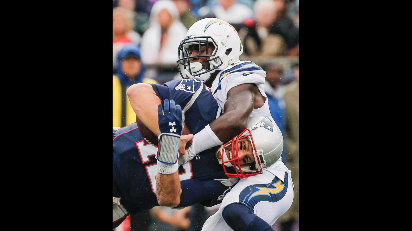 The Chargers' Desmond King tackles the Patriots' Tom Brady during the third quarter.