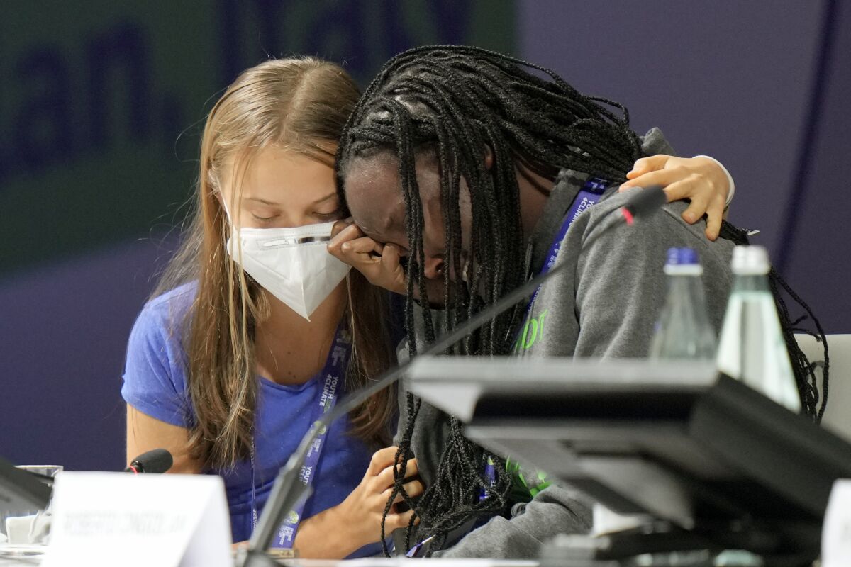 Ugandan climate activist Vanessa Nakate, right, is comforted by Swedish activist Greta Thunberg at a conference