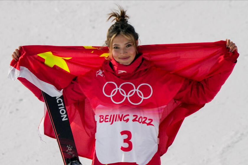 Silver medal winner China's Eileen Gu celebrates during the venue award ceremony for the women's slopestyle finals