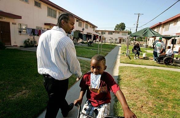 Fred "Scorpio" Smith, left, 37, has lived in the Jordan Downs public housing project in Watts most of his life. A new Jordan Downs that will cost more than $1 billion is being planned, and Smith is helping a team of consultants and architects understand the issues of the project's residents.