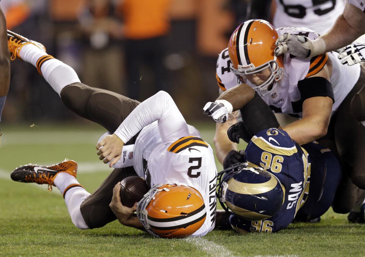Cleveland quarterback Johnny Manziel is sacked by St. Louis defensive end Michael Sam on Aug. 23.