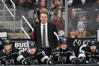 Kings coach Jim Hiller looks on from the bench.