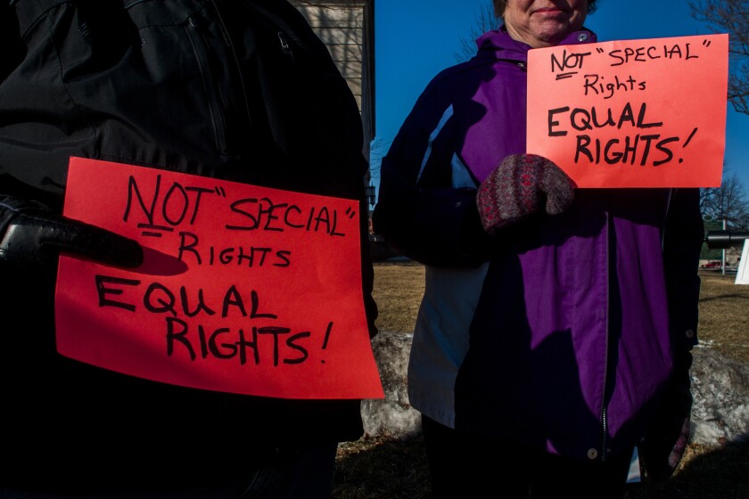 Two women participate in a pro-gay marriage rally held by the Unitarian Universalist Church of Flint, Mich., on Wednesday.