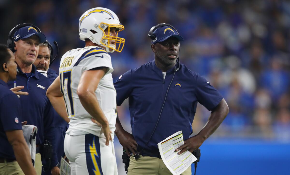 Chargers coach Anthony Lynn speaks with quarterback Philip Rivers during the second quarter of Sunday's 13-10 loss to the Detroit Lions.