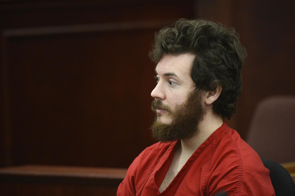 James Holmes sits in the courtroom during his arraignment in Centennial, Colo., on March 12. His trial is expected to begin in February 2014.