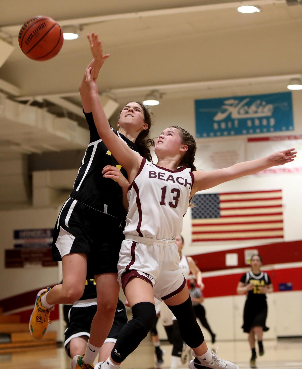 Laguna Beach sophomore Alexandra Grombchevsky (13) draws a foul on a drive to the basket against Los Angeles Yeshiva.