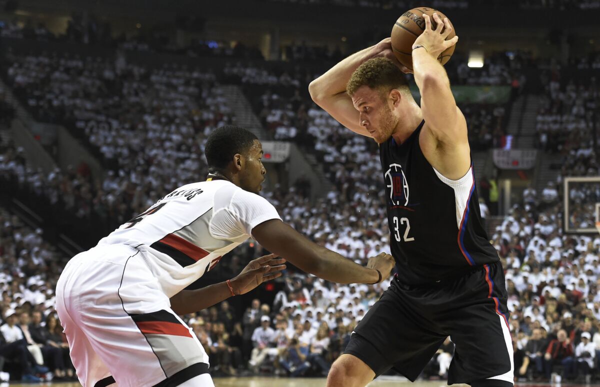 Clippers' Blake Griffin, right, looks to drive to the basket on Portland Trail Blazers' Maurice Harkless in the first quarter of Game 3 of the Western Conference first round playoff on Saturday.